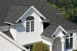 Gray asphalt shingle roof on a white home
